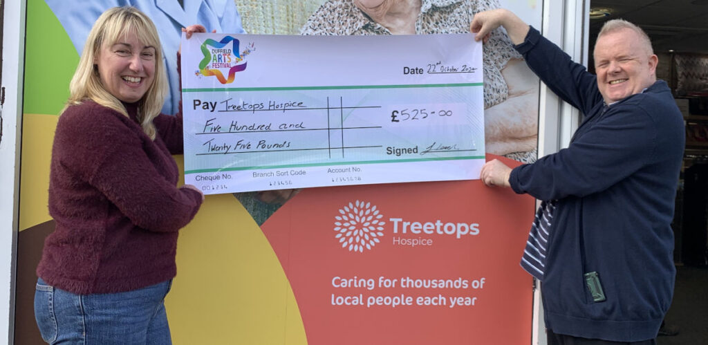 Treetops Hospice receiving their cheque for £525.